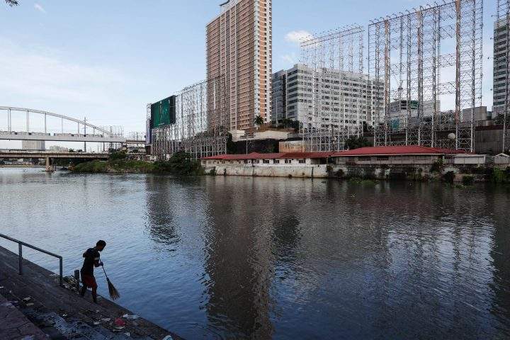 A man cleans stairs along a river with empty billboards in preparation for typhoon Goni in Pasay City, Philippines, 31 October 2020. According to reports, typhoon Goni is now a super typhoon with its winds forecasted to reach 249 kilometers per hour. Goni is expected to make landfall in the eastern provinces of Aurora and Quezon and make its way through Central Luzon on the evening of 01 November or morning morning of 02 November, according to the local weather bureau.  
