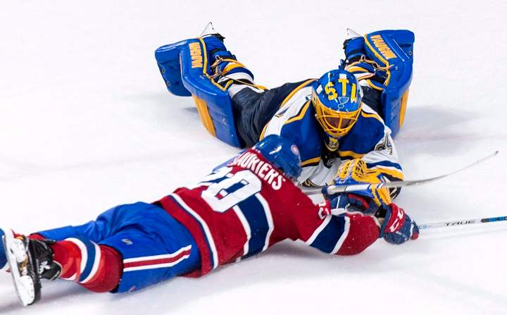 In this 2017 file photo, former St. Louis Blues goalie Jake Allen and Montreal Canadiens' Nicolas Deslauriers dive for the puck during NHL hockey action in Montreal. Allen signed a two-year contract extension with the Habs worth US US$2.875 million per season. Wednesday, Oct. 14, 2020.