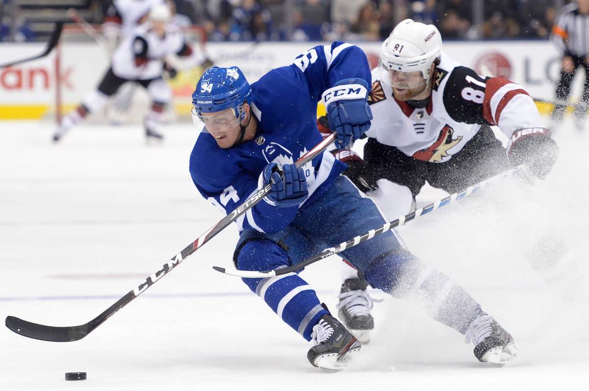 Tyson Barrie (94) turns hard with the puck as Arizona Coyotes right wing Phil Kessel (81) defends during first period NHL hockey action in Toronto on Tuesday Feb. 11, 2020. THE CANADIAN PRESS/Nathan Denette.