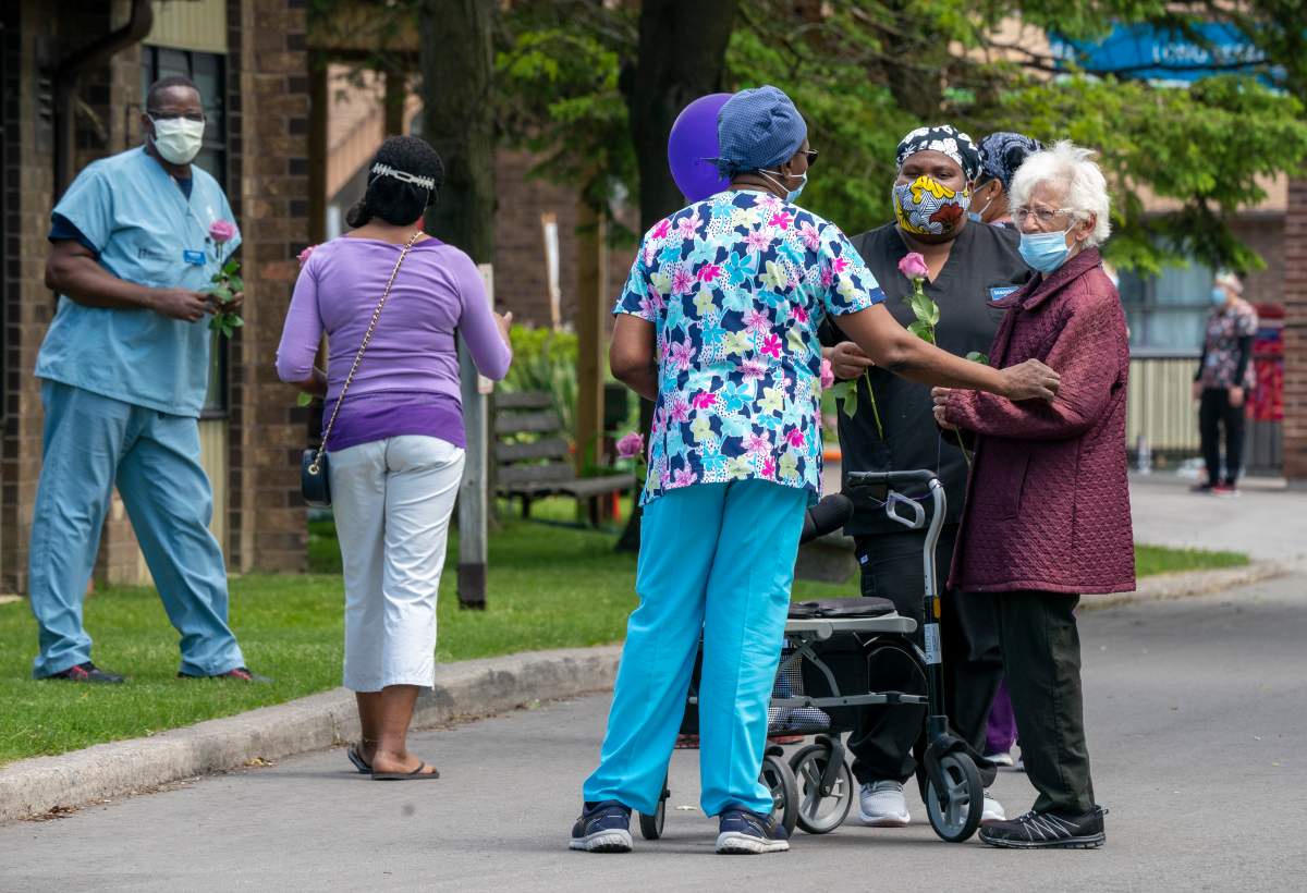 A resident chats with workers at Orchard Villa Long-Term Care in Pickering, Ontario on Monday June 1, 2020.  