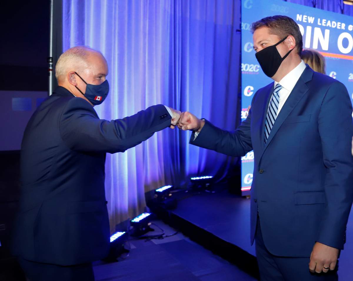 Conservative Party of Canada Leader Erin O'Toole fist bumps former leader Andrew Scheer after O'Toole's win at the 2020 Leadership Election, in Ottawa on Monday, Aug. 24, 2020. 
