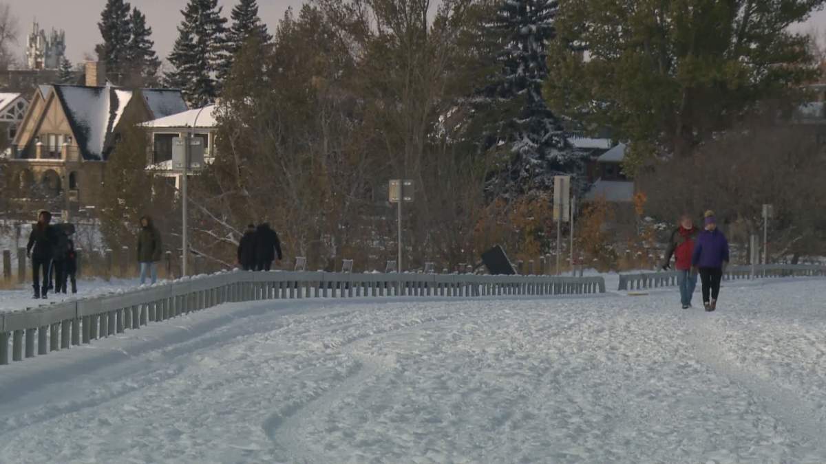 People walk on the closed road in Calgary on Saturday, Oct. 24, 2020, one day before it reopens to vehicles.