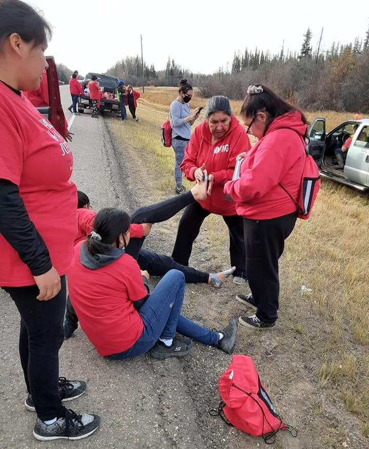 Women care for their feet during a 127 km walk from John D’Or Prairie to High Level in honour of two murdered Indigenous girls from their community.