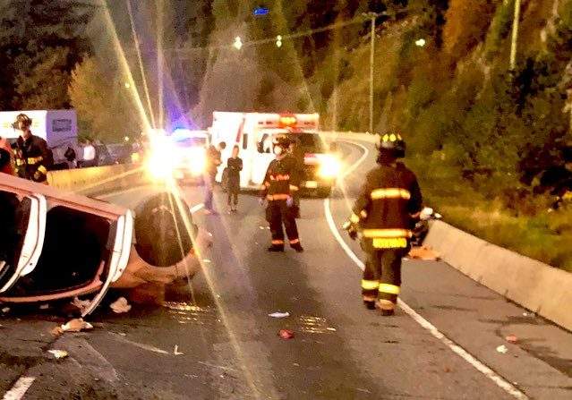 Squamish RCMP and firefighters on the scene of a single-vehicle collision on the Sea-to-Sky Highway south of Lions Bay, B.C., on Oct. 20, 2020.