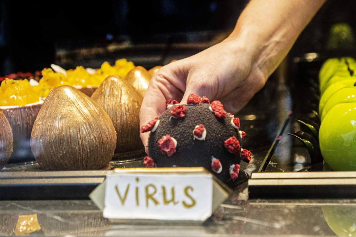 A waitress serves a dessert in shape of the Covid-19 coronavirus in a cafe on October 06, 2020 in Prague. 