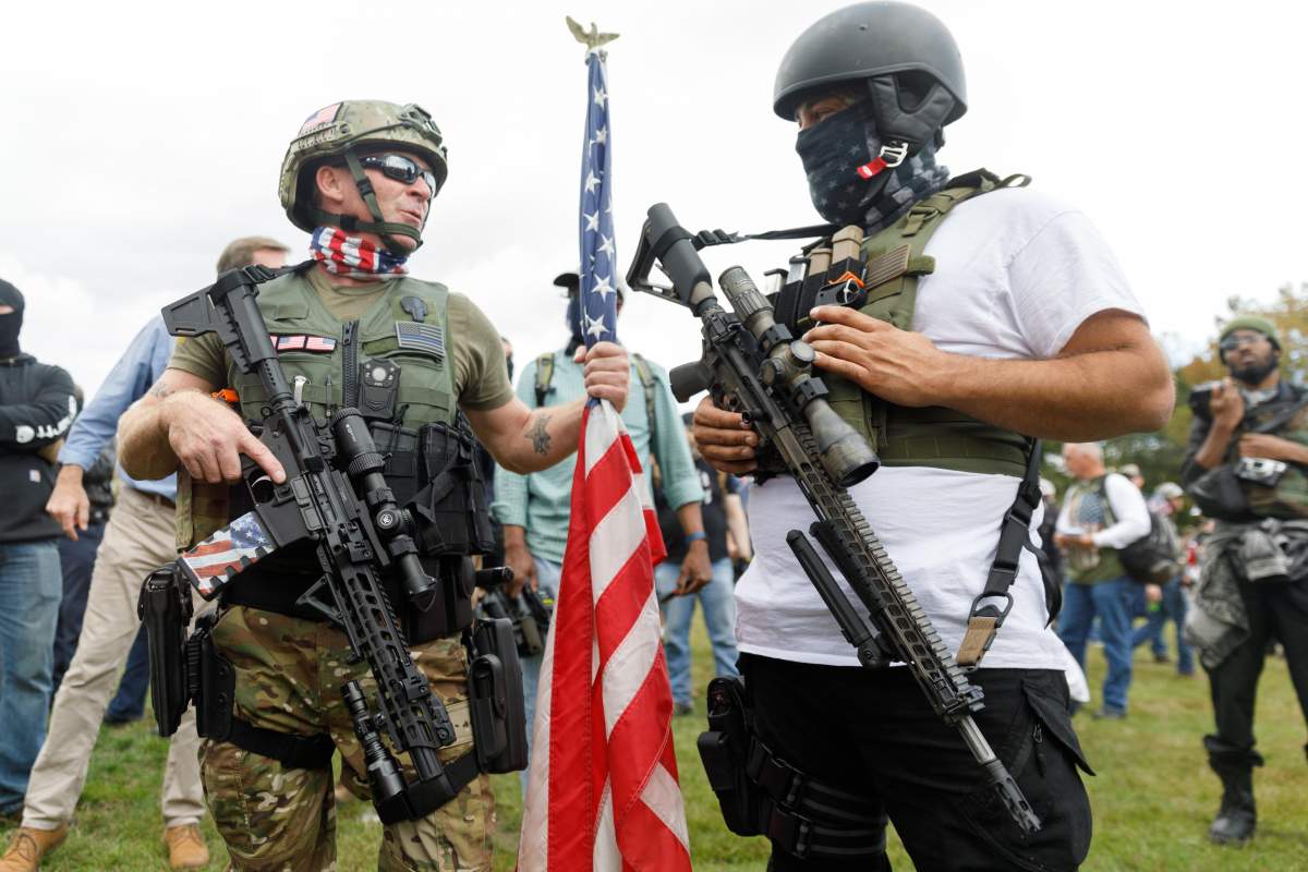 Armed with military weapons, members of the Proud Boys, a right-wing pro-Trump group, gather at a rally in Portland, Ore., on Sept. 26, 2020.