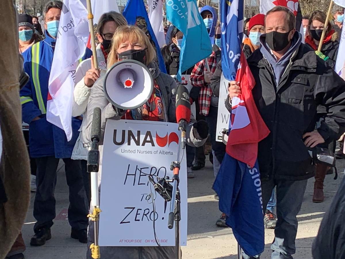 United Nurses of Alberta (UNA) president Heather Smith (middle) and Health Sciences Association of Alberta (HSAA) president Mike Parker (right) speak at the AUPE picket line outside the Royal Alexandra Hospital on Monday, October 26, 2020.