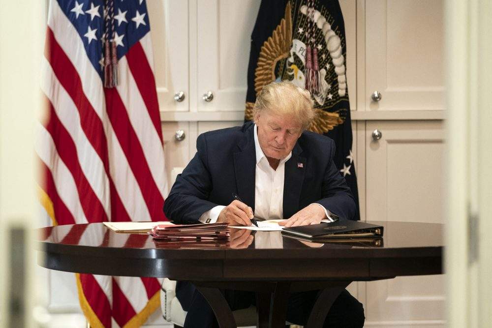 In this photo released by the White House, United States President Donald J. Trump works in the Presidential Suite at Walter Reed National Military Medical Center in Bethesda, Md., on Oct. 3, 2020, after testing positive for COVID-19.