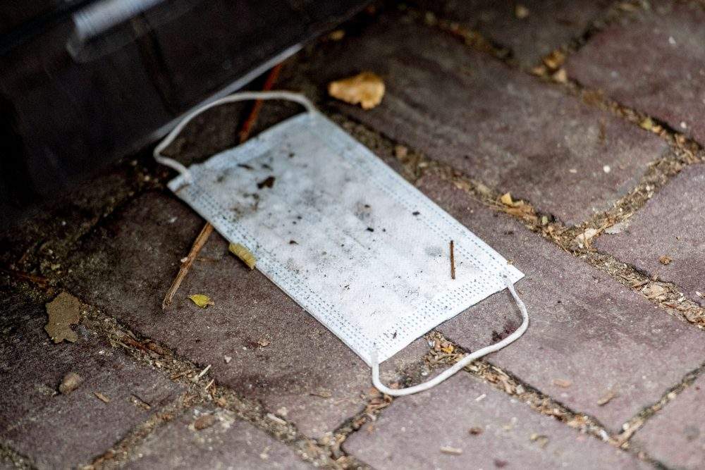 A discarded face mask is shown in this file photo from July 28, 2020.