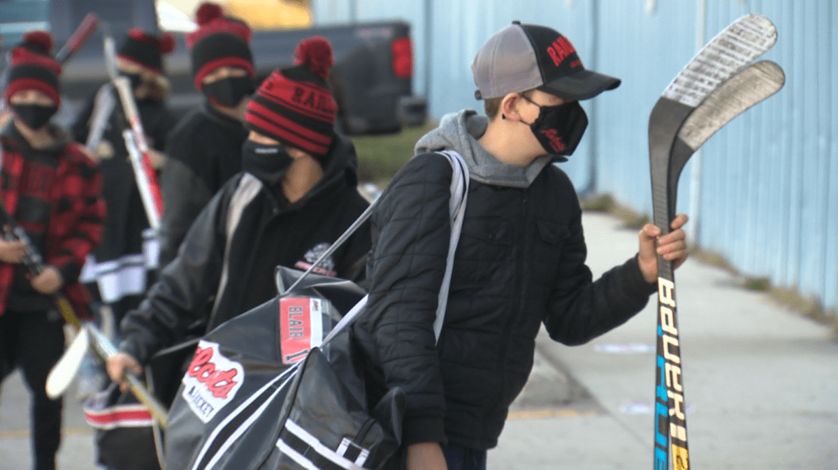 The Winnipeg East Railcats waiting to enter Southdale arena one by one for COVID-19 screening.