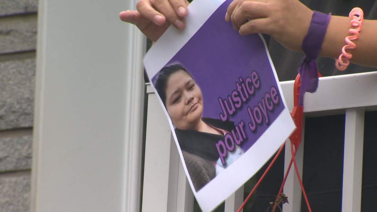 A woman holds up a sign that reads 'Justice for Joyce,' on September 29, 2020. The head of the regional health board that oversees the hospital where Joyce Echaquan died has been replaced. Wednesday, Dec. 2, 2020,.