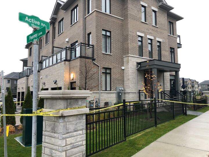 A photo of police tape surrounding a townhouse following a homicide in Markham.