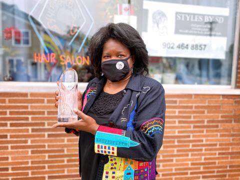 Styles by SD owner Samantha Dixon Slawter proudly shows off her 2020 Gloria Fisher Business Person of the Year Award.