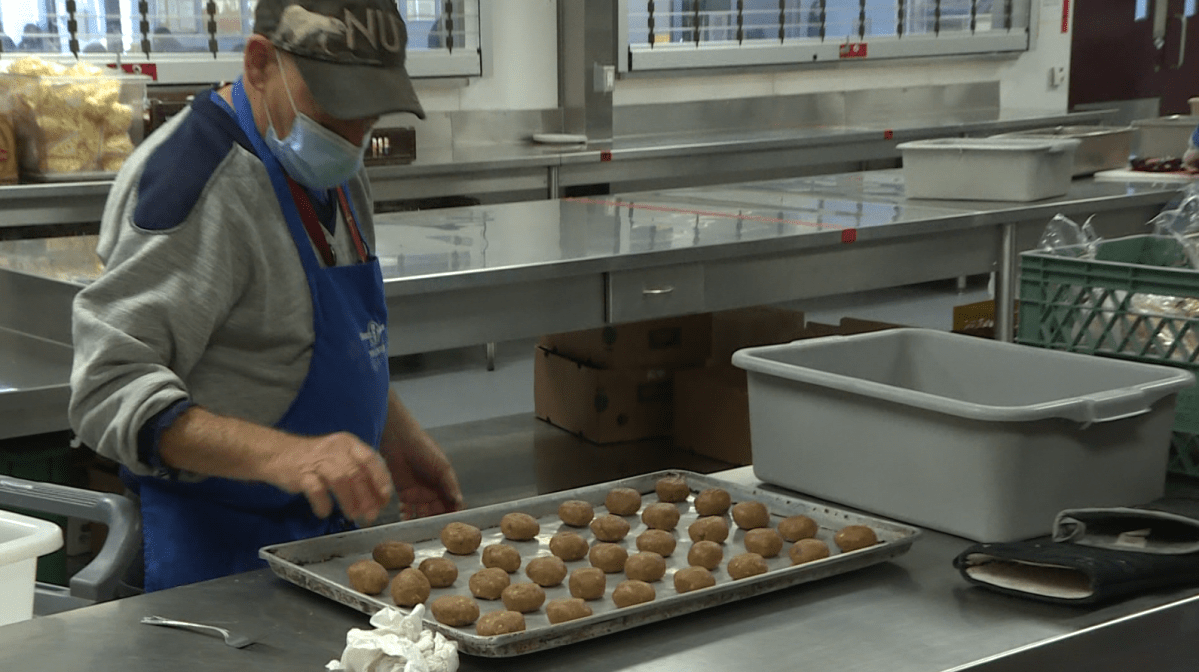 A volunteer at Siloam Mission preparing food in the facility's new kitchen.