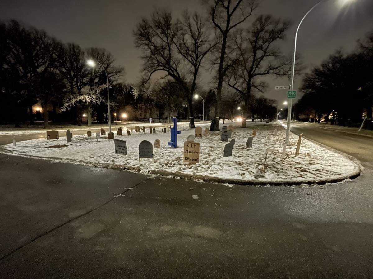 65 cardboard gravestones litter the boulevard outside Manitoba Premier Brian Pallister’s home.
