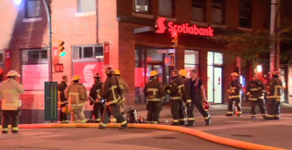 Vancouver firefighters remained on the scene of a rooftop fire in Yaletown to extinguish any remaining hotspots Sunday evening.