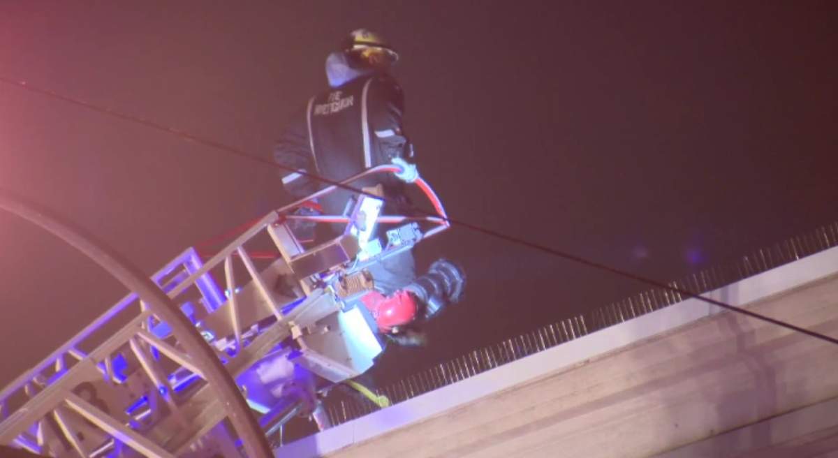 A Vancouver firefighter inspects the rooftop of a Yaletown commercial building that caught fire due to a faulty HVAC system Sunday evening.