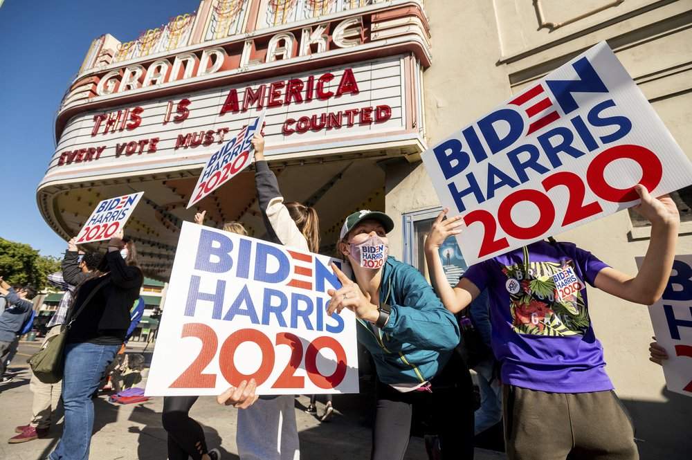 Meredith Walsh celebrates the victory of President-elect Joe Biden and Vice President-elect Kamala Harris in Oakland, Calif., on Saturday, Nov. 7, 2020. Biden defeated President Donald Trump to become the 46th president of the United States on Saturday, positioning himself to lead a nation gripped by the historic pandemic and a confluence of economic and social turmoil.