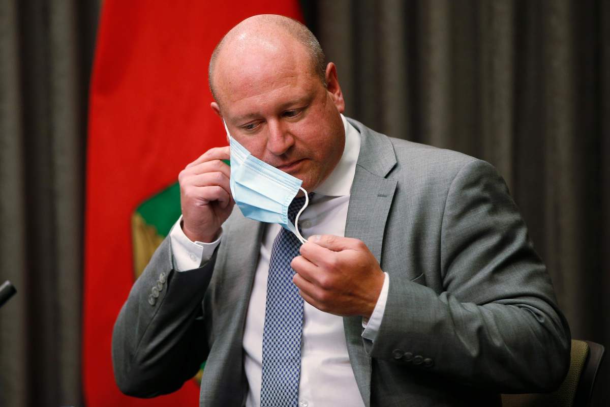 Dr. Brent Roussin, Manitoba chief public health officer, takes off his mask to speak during the province's latest COVID-19 update at the Manitoba legislature in Winnipeg Friday, October 30, 2020. 