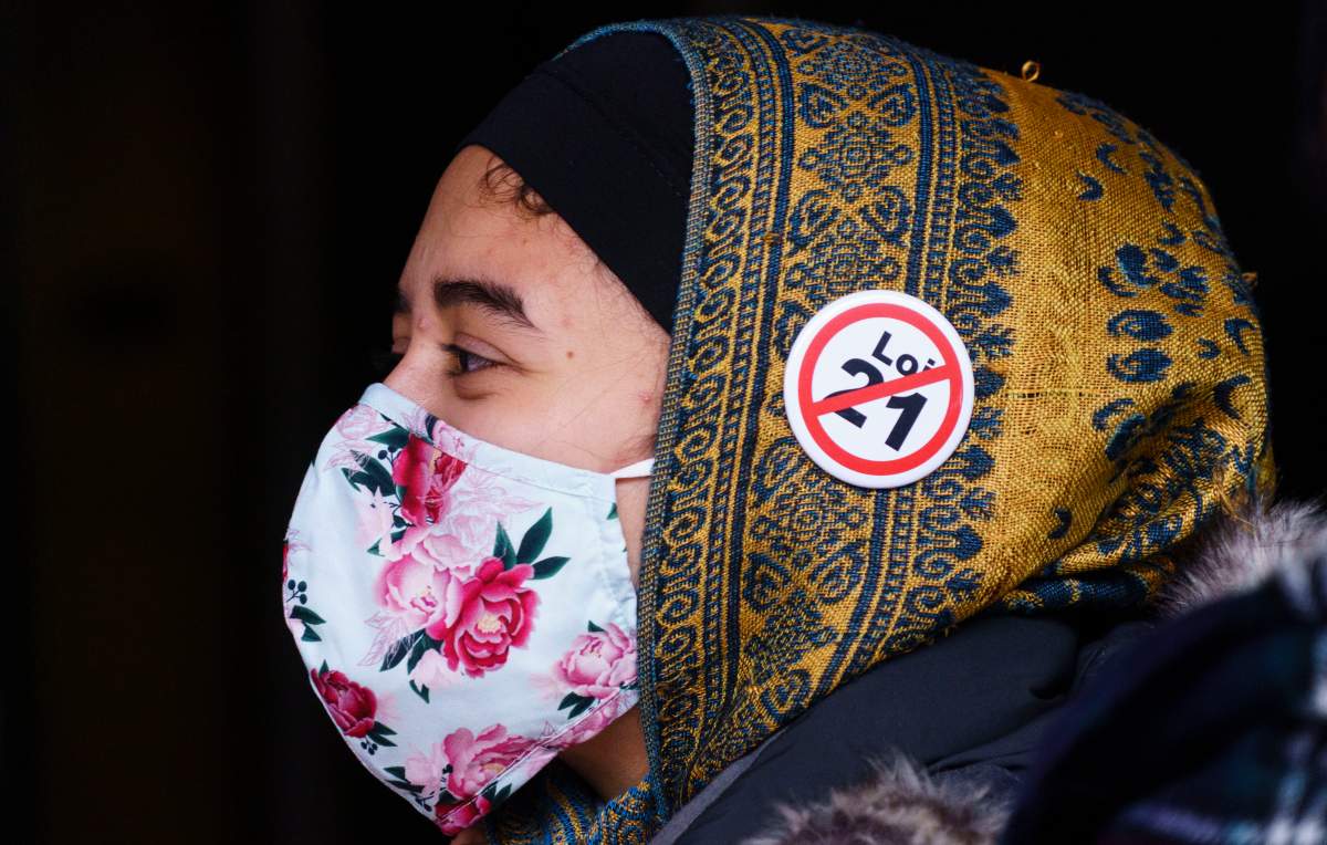 A demonstrator displays her opinion  outside the courthouse on the first day of the constitutional challenge to Bill 21 before the Quebec Superior Court in Montreal on Monday, November 2, 2020. On Tuesday March 30, 2024, two more groups have joined a bid to get the Supreme Court of Canada to rule on the constitutionality of Quebec's secularism law. Their decision follows that of a major Quebec teachers' union and the English Montreal school board's move to contest the law. They insist Bill 21 is rooted in discrimination and question the government's use of the notwithstanding clause. (Photo: Paul Chiasson/The Canadian Press - File).