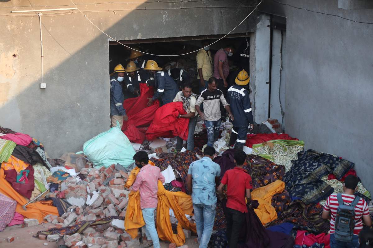 Rescuers look for survivors at the site of fire at a factory in an industrial area on the outskirts of Ahmedabad, India, Nov. 4, 2020.