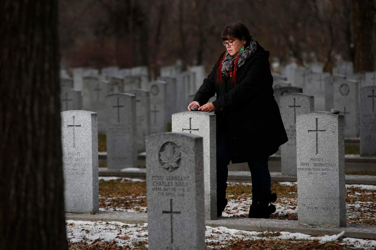 Julie Mungall is commemorating Remembrance Day by painting poppies and other designs on rocks and hiding them around Winnipeg, sometimes in plain sight.