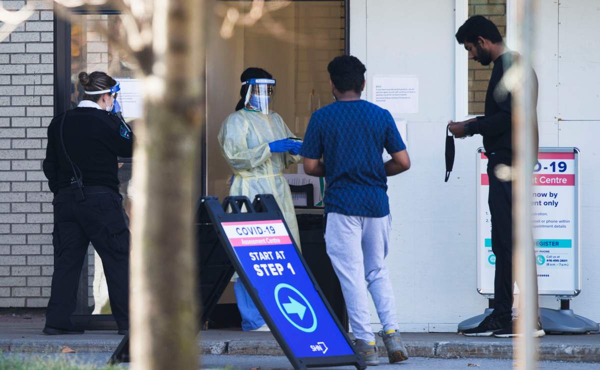 TORONTO, Nov. 8, 2020  A medical worker wearing protective gear looks at a man's health card at a COVID-19 assessment center in Toronto, Canada, on Nov. 8, 2020. Canada reported a total of 264,045 cases of COVID-19 and 10,522 deaths as of Sunday afternoon, according to CTV. (Photo by Zou Zheng/Xinhua) (Credit Image: © Zou Zheng/Xinhua via ZUMA Press).