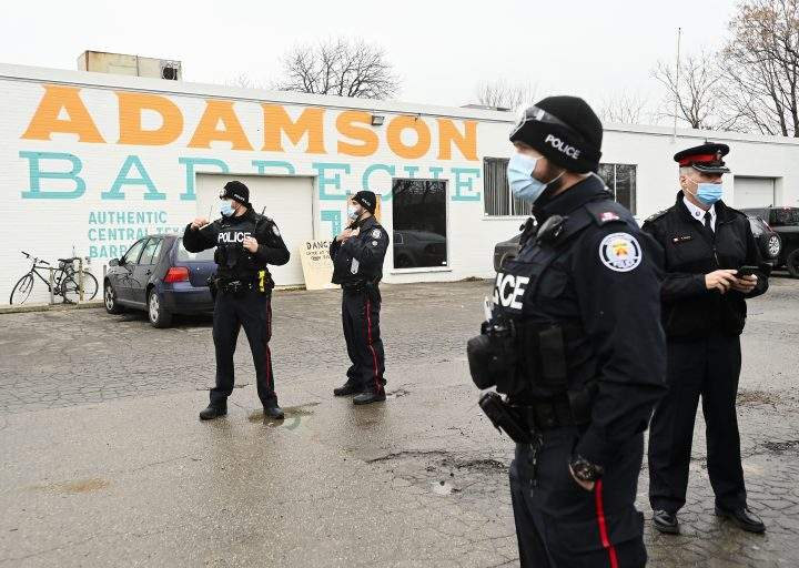 Police at Toronto’s Adamson Barbecue after the restaurant allegedly defied pandemic lockdown orders, Nov. 25, 2020.