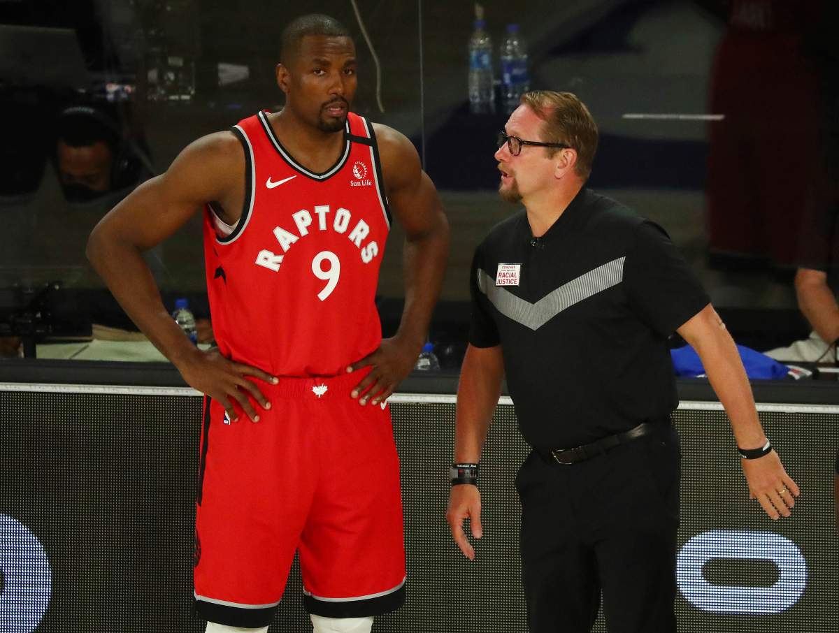 Toronto Raptors centre Serge Ibaka (9) speaks with head coach Nick Nurse during a game against the Brooklyn Nets during the first half of Game 4 of an NBA basketball first-round playoff series, Sunday, Aug. 23, 2020, in Lake Buena Vista, Fla. 