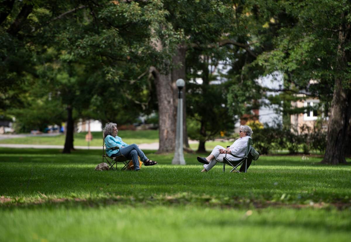 People sit in lawn chairs as they talk at Commissioners Park in Ottawa on the Labour Day long weekend, Sunday, Sept. 6, 2020, in the midst of the COVID-19 pandemic. A new report on search trends in Ottawa reveals a spike in searches for local parks and outdoor activities from March to October, 2020.