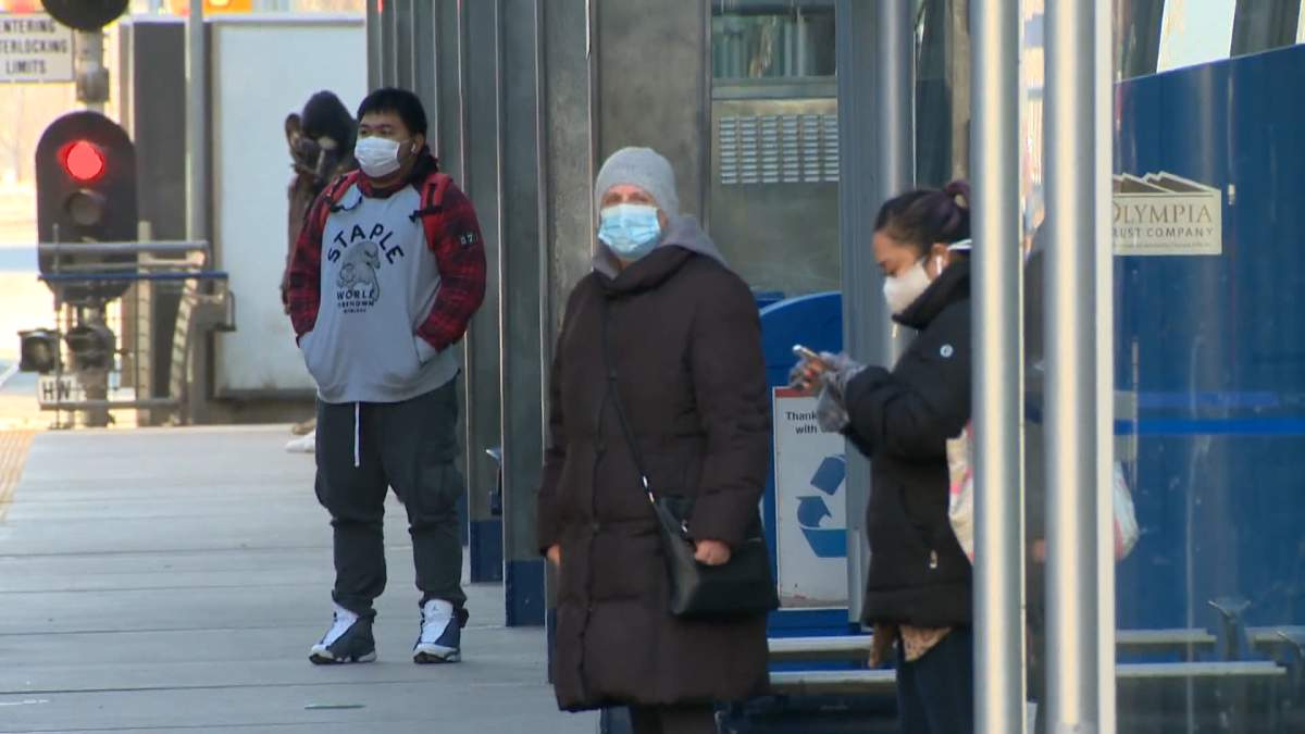 People wearing face masks are seen in downtown Calgary.