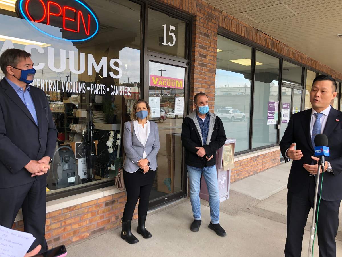 Stan Cho, the Parliamentary Assistant to Ontario's Finance Minister, talks to reporters outside of Peterborough Vacuum on Nov. 13.