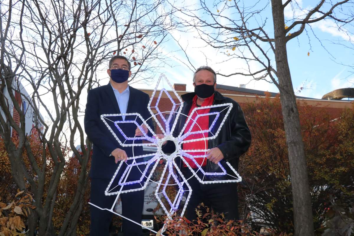 Peterborough-Kawartha MPP Dave Smith and Terry Guiel of Downtown Business Improvement Area of Peterborough showcase new downtown ornaments.