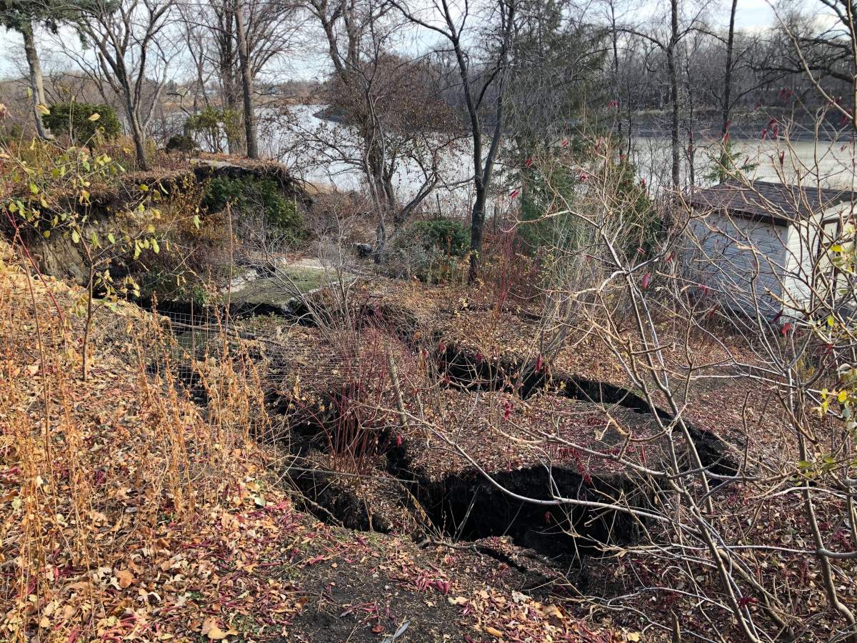 The sprawling riverfront properties have been cleaved in half after the Red River’s bank collapsed Monday.
