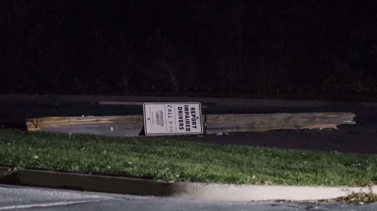 Kingston police have charged a man with impaired driving after his car struck a hydro pole sporting a sign that said 'Report Impaired Drivers.'.