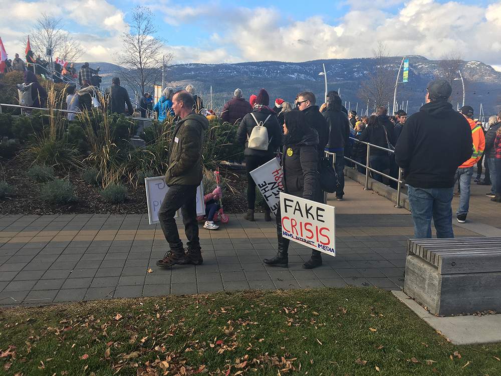 Around 100 mask-less protesters gathered at Stuart Park in downtown Kelowna on Saturday.