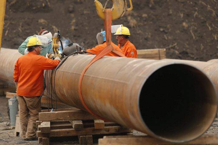 Enbridge workers weld pipe just west of Morden, Man., Thursday, Aug. 16, 2018. A press conference and tour of a Line 3 site for federal, provincial, municipal and indigenous leaders was held at the site. 