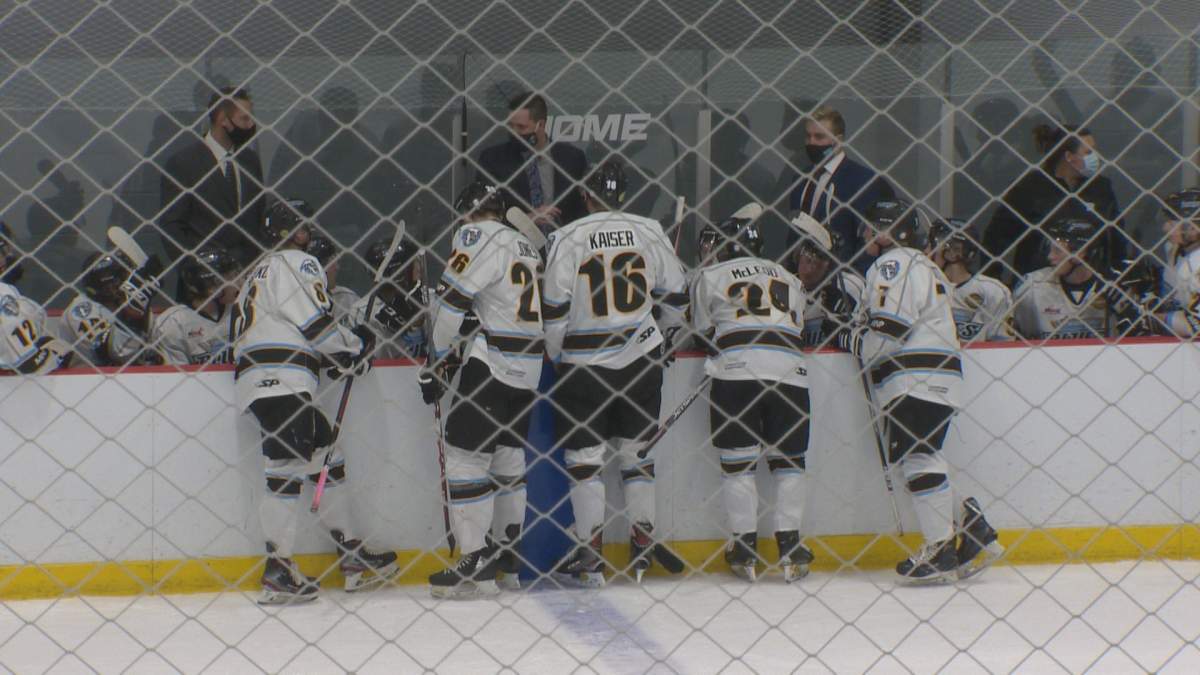 The Winnipeg Blues talk things over at the bench in play in the Manitoba Junior Hockey League.