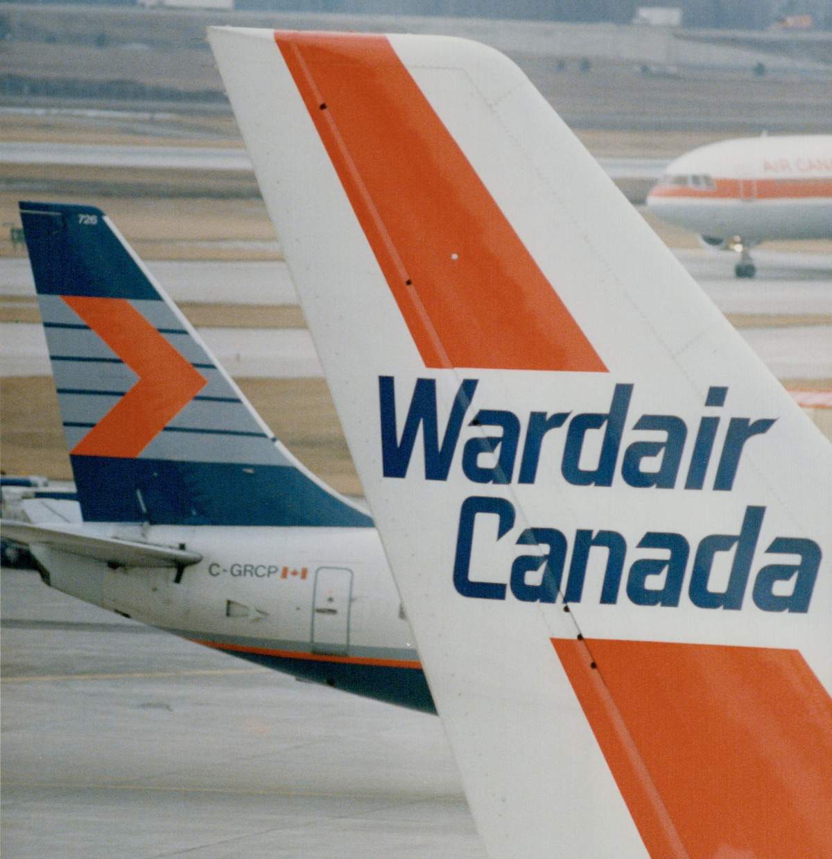 Wardair and Canadian Airlines jets on a tarmac.
