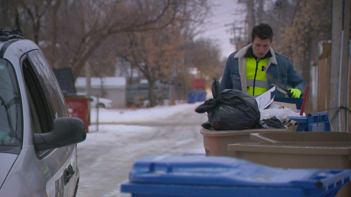 Queen City Patrol volunteer Matthew Gillingham examines the ground around a garbage can for IV needles and other dangerous paraphernalia.