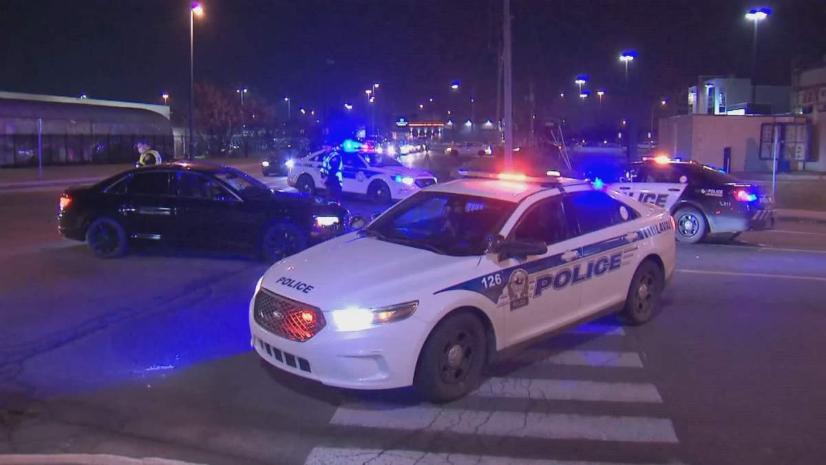 Laval police intervene during a gathering in the parking lot of a Walmart on Saturday, Nov. 7, 2020.