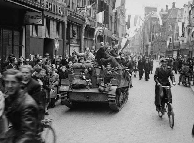 Dutch civilians on a WASP (Universal Carrier fitted with a flamethrower) of 7th Reconnaissance Regiment (17th Duke of York’s Royal Canadian Hussars), 3rd Canadian Infantry Division, celebrating the liberation of Zwolle, Netherlands, 14 April 1945