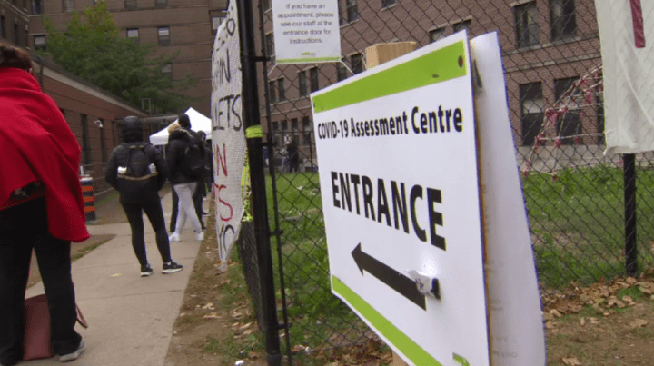A sign identifying the entrance to a COVID-19 assessment centre.