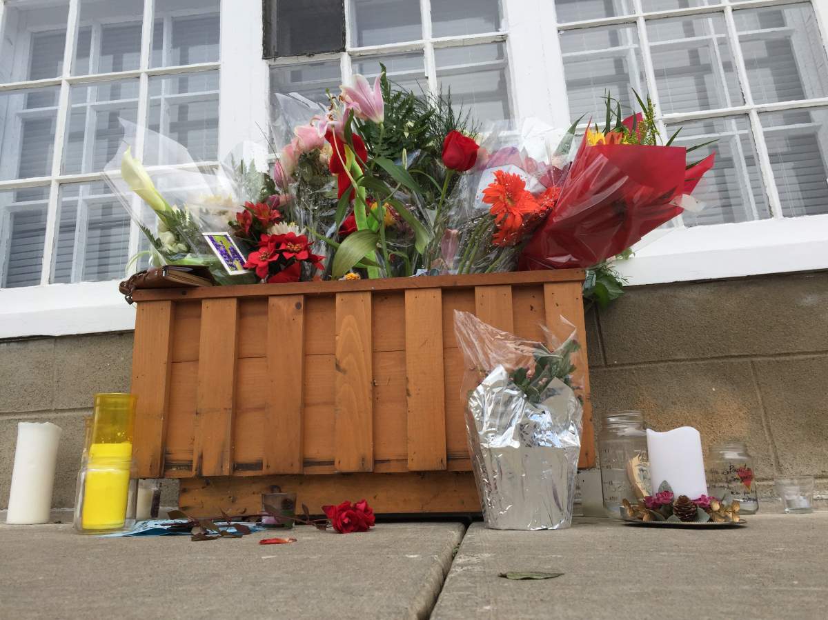 Flowers are laid outside the home of Suzanne Clermont. She was one of two victims killed on Halloween night in Quebec City.