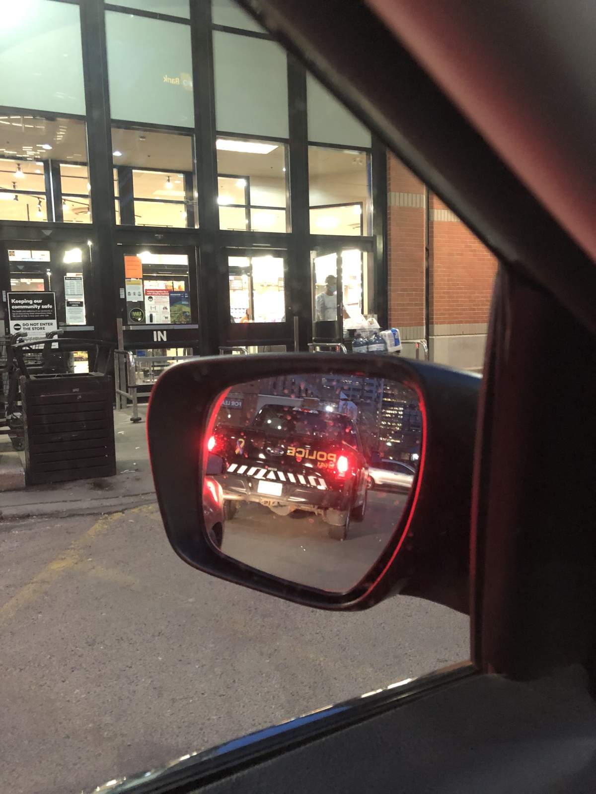 Photo of police car driving away.