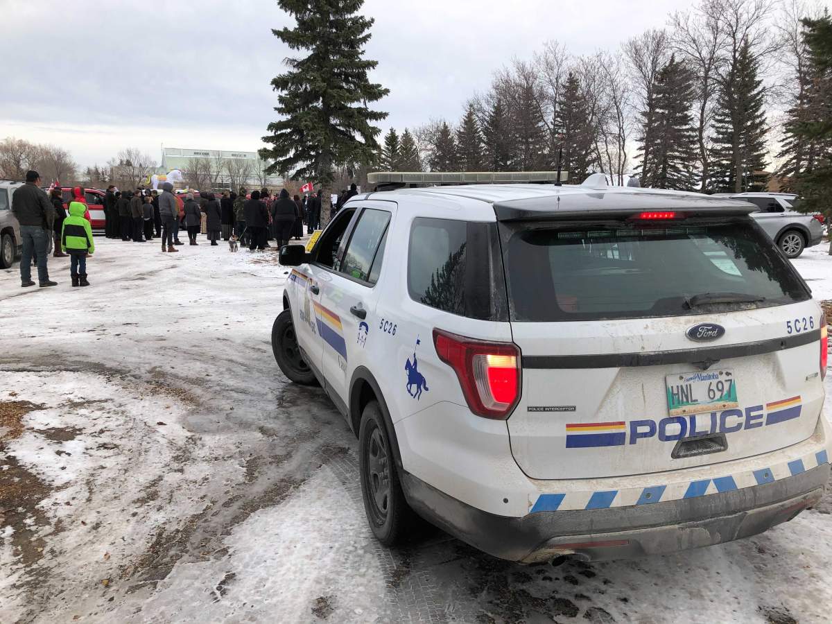 RCMP at the Hugs over Masks rally in Steinbach, Man., Saturday.