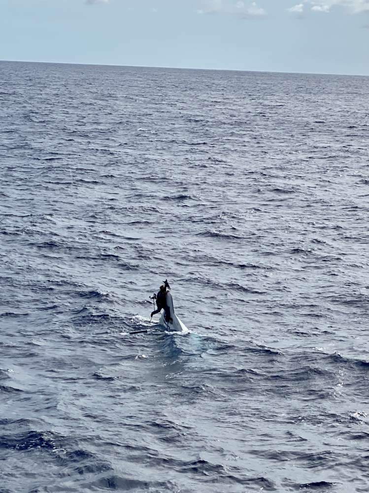 Richard Bee is shown clinging to his capsized ship, the Stingray, in this image captured on Nov. 29, 2020.