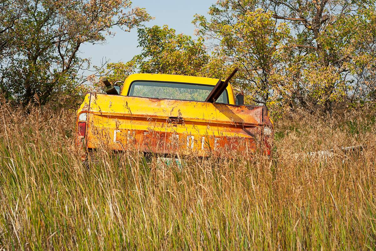 A decaying truck in a field near Mazenod, Sask. in 2018. Webber documents what happens to small towns after people leave or as the town shrinks. He hopes to show how people used to live by capturing what remains of their lives.