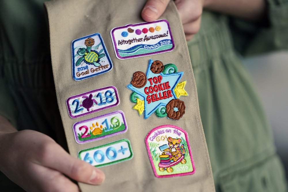Olivia Chaffin, 14, displays merit badges Nov. 1, 2020, that she has been awarded for selling Girl Scout Cookies in Jonesborough, Tenn. She was a top cookie seller in her troop when she first heard rainforests were being destroyed to produce palm oil.