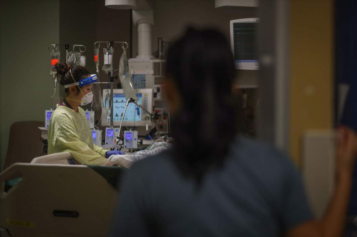 Front-line health-care workers in Alberta help COVID-19 patients in hospital.